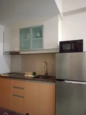 a kitchen with a refrigerator and a microwave at 101 Newport Boulevard -Terminal 3 Airport in Manila