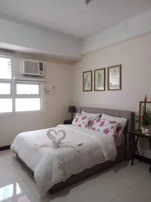 a bedroom with a large bed and a window at 101 Newport Boulevard -Terminal 3 Airport in Manila