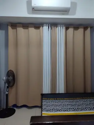 a curtain in a room with a fan at 5 Years Legit Staycation Infront of Moa, Moa Arena, Smx, Ikea, Sea Residences Tower A Near Dfa Macapagal, NU Moa, PICC, World Trade, Star City, Ayala Mall, Parqal Mall, NAIA 1,2,3 in Manila