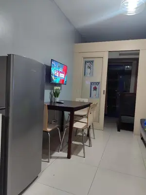 a dining room with a table with chairs and a tv at 5 Years Legit Staycation Infront of Moa, Moa Arena, Smx, Ikea, Sea Residences Tower A Near Dfa Macapagal, NU Moa, PICC, World Trade, Star City, Ayala Mall, Parqal Mall, NAIA 1,2,3 in Manila