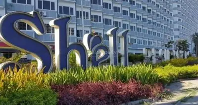 a sign for a hotel in front of a building at vin's place 1br amenities view at Shell Residence in Manila