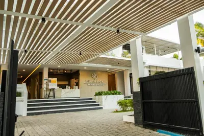 a building with a wooden pergola in front of it at SOUTHPICKRESORT & HOTEL INC. in Aplaya