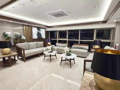a living room with couches and tables and windows at SMDC Coast Residences near PICC in Manila