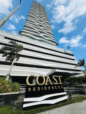 a hotel sign in front of a tall building at SMDC Coast Residences near PICC in Manila