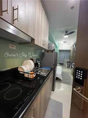 a kitchen with a counter top with a stove top oven at SMDC Coast Residences near PICC in Manila