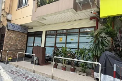 a store front with plants in front of a building at Propiedad Residences Makati in Manila