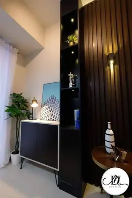 a room with a black cabinet with a table in it at DM's Place at S Residences MOA in Manila