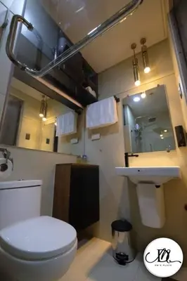 a bathroom with a white toilet and a sink at DM's Place at S Residences MOA in Manila
