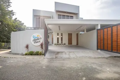 a white building with a sign on the front of it at Addie's Place Camella Homes 2D Muntinlupa in Manila