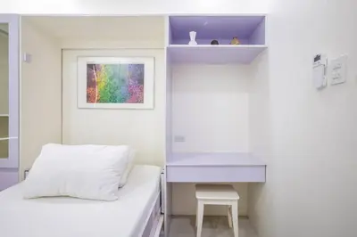 a bedroom with a bed and a desk and a window at Addie's Place Camella Homes 2D Muntinlupa in Manila