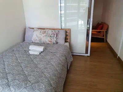 a bedroom with a bed with two towels on it at Azure Urban Resort Residence A3 in Manila