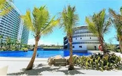 a group of palm trees in front of a building at Azure Urban Resort Residence a2 in Manila