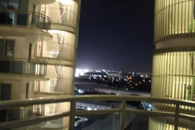 a view of a building and a parking lot at night at Azure Urban Resort Residence A1 in Manila