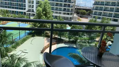 a balcony with a table and a view of a pool at Azure Urban Resort Residence A1 in Manila