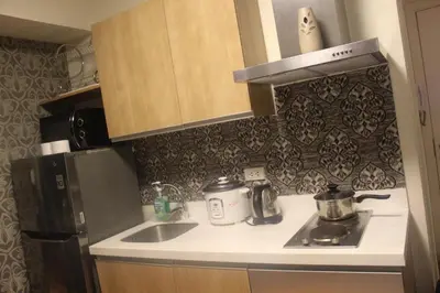 a small kitchen with a sink and a refrigerator at Azure Urban Resort Residence A1 in Manila