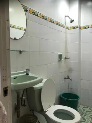 a bathroom with a toilet and a sink at THE MANSION - NEAR AIRPORT BIG FAMILY Lodge in Manila