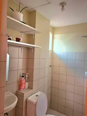 a bathroom with a toilet and a sink at Pet Friendly Staycation near Villa Ardin in Cainta
