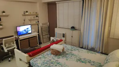 a living room with a bed with a slide on it at Palm Tree Villas Condominium by Beth in Manila