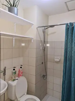 a bathroom with a shower and a toilet and a sink at Affordable Staycation in Valley Mansions near Sitio Elena Events Place in Cainta