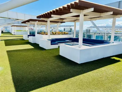 a row of benches on the roof of a building at Azure Pool View with Balcony, WiFi and Netflix in Manila