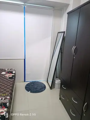 a bedroom with a bed and a sliding glass door at Jamescrabsea residences in Manila