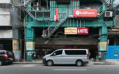 a silver van parked in front of a building at RedDoorz @ Riches Holiday Hotel Avenida in Manila
