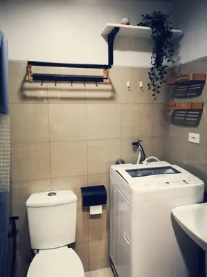 a small bathroom with a toilet and a sink at Serenity Cove MOA in Manila