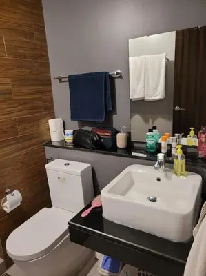 a bathroom with a white toilet and a sink at The Radiance by Dominga in Manila