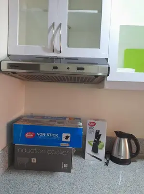 a kitchen counter with a box and a microwave at Stanford Suites 2 Lilian in Silang
