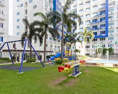 a playground in a park in front of a building at 5 Years Legit Staycation Infront of Moa, Arena, Smx, Ikea, Sea Residences Tower A, Near Dfa Macapagal, Ayala Mall, World Trade, Naia123 in Manila