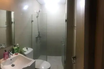 a bathroom with a glass shower and a sink at Lovely 2 Bed Room condo infront of NAIA Terminal 3 in Manila