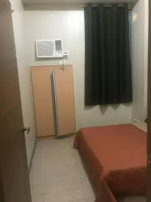 a small room with two beds and a window at Lovely 2 Bed Room condo infront of NAIA Terminal 3 in Manila