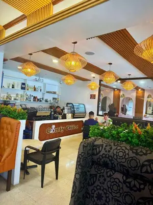 a restaurant with people sitting at a counter and lights at Comfy Inn Mabini Manila in Manila