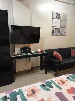 a living room with a desk and a couch at Katliza Condotel Kassel Residences in Manila