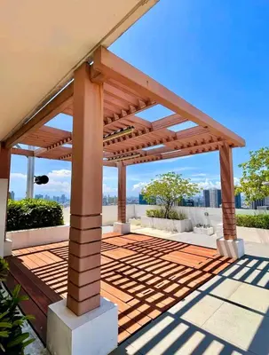 a wooden pergola on top of a house at LukeatSkye Suite - The Beacon Makati in Manila