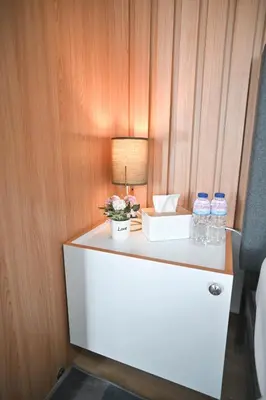 a table with a lamp and water bottles on it at Belles Home Relaxing Place SMDC Hope Residences in Trece Martires