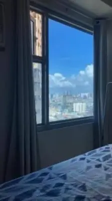 a bedroom with a window with a view of a city at Staycation in Manila (2 min. walk to Robinson's) in Manila