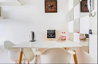 a white table and chairs in a room at Staycation in Manila (2 min. walk to Robinson's) in Manila