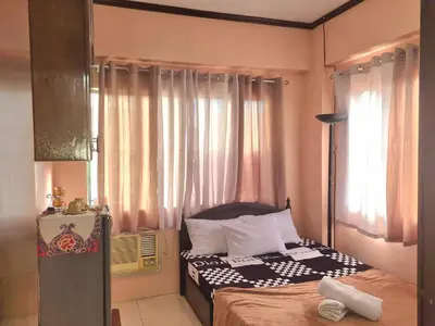 a small bedroom with a bed and a window at Budget Friendly Staycation in Valley Mansions in Cainta