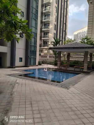 a swimming pool with a gazebo and buildings at RQUI CONDOTEL NEAR AIRPORT & Resorts World Manila in Manila