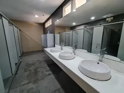 a large bathroom with three sinks and mirrors at U806 2Bedrooms PoolAccess Netflix wifi85mbps Karaoke in Manila