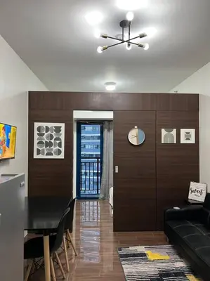 a living room with a couch and a dining room table at Air Residences - 1Bedroom Unit with Balcony - Wifi & Netflix in Manila