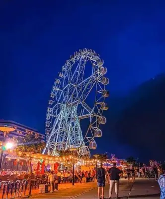 a large ferris wheel at a carnival at night at SHELL RESIDENCE c7 shortwalk MALL OF ASIA in Manila