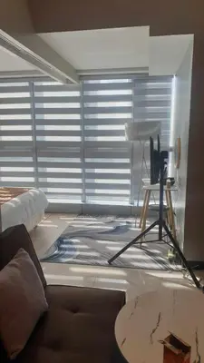 a living room with a couch and a table at Uptown Parksuites Tower 1 BGC in Manila