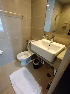 a bathroom with a sink and a toilet at Uptown Parksuites Tower 1 BGC in Manila