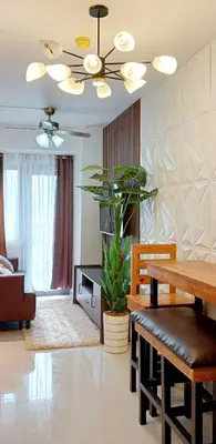 a living room with a dining table and a ceiling fan at MOA S Residences 1BR Condo Stunning Boutique T3 in Manila