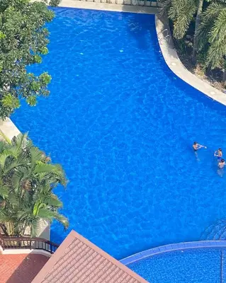 an overhead view of a large blue swimming pool at staycation affordable alabang in Manila