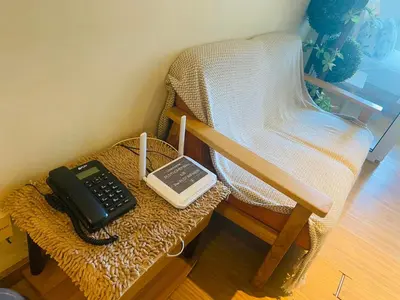 a phone sitting on a table next to a chair at Azure Residence B1 Free wi-fi Near Sm Mall Airport in Manila