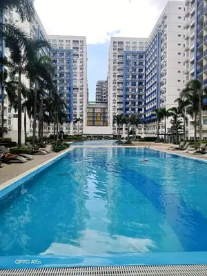 a large blue swimming pool with tall buildings at Lyndon at Sea Residences, SMDC MOA Complex, Pasay City, Philippines in Manila