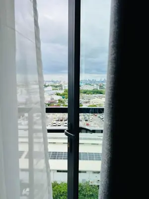 a window with a view of a parking lot at OneTiago Staycation - Spring Residences Paranaque in Manila